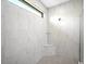 Stylish walk-in shower with marble tile and a modern design at 4988 Fairhope Cir, Lakewood Ranch, FL 34211