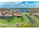 Expansive aerial view of the homes along a lake, showcasing well-manicured lawns and waterfront access at 501 Maraviya Blvd, Nokomis, FL 34275