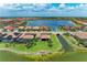Expansive aerial view of the homes along a lake, showcasing well-manicured lawns and waterfront access at 501 Maraviya Blvd, Nokomis, FL 34275