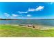 Backyard with dock and seating overlooking the water, ideal for relaxing and enjoying the waterfront scenery at 501 Maraviya Blvd, Nokomis, FL 34275