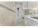 Modern bathroom featuring a glass-enclosed shower with a built-in bench and dual sink vanity at 501 Maraviya Blvd, Nokomis, FL 34275