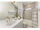 Bright bathroom with a large mirror, elegant fixtures, and a shower-tub combination at 501 Maraviya Blvd, Nokomis, FL 34275