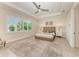 Bright bedroom featuring a ceiling fan, natural light, and calming neutral tones at 501 Maraviya Blvd, Nokomis, FL 34275