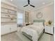 Cozy bedroom featuring built-in bookshelves, a window seat, and a comfortable bed at 501 Maraviya Blvd, Nokomis, FL 34275