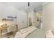 Bright bedroom features a built-in desk, a closet, and an ensuite bathroom with neutral tones and lots of light at 501 Maraviya Blvd, Nokomis, FL 34275