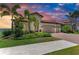Beautiful single-Gathering home with a two car garage and brick paver driveway at sunset at 501 Maraviya Blvd, Nokomis, FL 34275