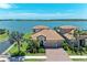 Stunning waterfront home boasts lush landscaping, a tile roof, and brick driveway at 501 Maraviya Blvd, Nokomis, FL 34275