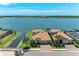 Waterfront property with a tile roof and paver driveway offers stunning views of the adjacent lake at 501 Maraviya Blvd, Nokomis, FL 34275