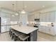 Modern kitchen featuring an island with seating, pendant lighting, and stainless steel appliances at 501 Maraviya Blvd, Nokomis, FL 34275