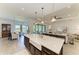 Open kitchen boasts granite counters, a large island, and a seamless flow into the dining area at 501 Maraviya Blvd, Nokomis, FL 34275