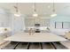 Stylish kitchen with an island, pendant lighting, and stainless steel appliances at 501 Maraviya Blvd, Nokomis, FL 34275