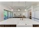Open concept kitchen with a large island overlooking the living area at 501 Maraviya Blvd, Nokomis, FL 34275
