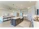 Spacious kitchen with large island, pendant lighting, and open floor plan at 501 Maraviya Blvd, Nokomis, FL 34275