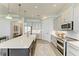 Bright, open kitchen features a large island, white cabinets, and modern appliances at 501 Maraviya Blvd, Nokomis, FL 34275