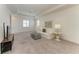 Bright living room featuring plush carpeting, comfortable seating, and a view of the water from the large window at 501 Maraviya Blvd, Nokomis, FL 34275
