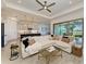 Bright living room with a plush sofa, access to the kitchen and views of the water at 501 Maraviya Blvd, Nokomis, FL 34275