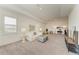 Spacious, well-lit living room featuring plush carpeting, large windows, and comfortable seating arrangements at 501 Maraviya Blvd, Nokomis, FL 34275