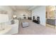 Large living room featuring plush carpeting, comfortable seating and an ensuite bathroom with modern finishes at 501 Maraviya Blvd, Nokomis, FL 34275