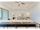 Inviting living area featuring comfortable seating, a ceiling fan, TV, and access to the outdoors at 501 Maraviya Blvd, Nokomis, FL 34275