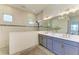 Modern main bathroom with double sinks, stylish fixtures, and glass-enclosed shower at 501 Maraviya Blvd, Nokomis, FL 34275