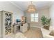 Bright office featuring a large desk, comfortable seating, stylish light fixture, and ample storage at 501 Maraviya Blvd, Nokomis, FL 34275