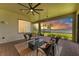 Relaxing covered patio with brick flooring, comfortable seating, and stunning lake views at sunset at 501 Maraviya Blvd, Nokomis, FL 34275