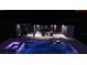 Stunning backyard pool and patio area illuminated at night with spa and sun loungers at 501 Maraviya Blvd, Nokomis, FL 34275