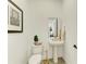 Bright powder room featuring a pedestal sink, decorative mirror, and modern fixtures at 501 Maraviya Blvd, Nokomis, FL 34275