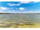 Expansive waterfront view with calm waters and clear blue sky, providing a serene backdrop at 501 Maraviya Blvd, Nokomis, FL 34275