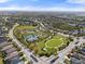 Community aerial view featuring sports fields, tennis courts, a playground, splash pad, and lush landscaping at 5047 Newport News Cir, Bradenton, FL 34211