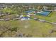 Aerial view of community park amenities with tennis courts, playground, and green spaces at 5047 Newport News Cir, Bradenton, FL 34211