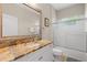 Bathroom features a stone countertop vanity, a large mirror, and glass enclosed shower at 5047 Newport News Cir, Bradenton, FL 34211