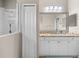 Bathroom features a marble countertop vanity, a large mirror, and glass enclosed shower at 5047 Newport News Cir, Bradenton, FL 34211