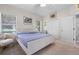 Bright bedroom features a white bed frame, ceiling fan, and large windows for natural light at 5047 Newport News Cir, Bradenton, FL 34211