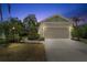 Exterior home view featuring a two-car garage, well-maintained lawn, and lush landscaping at 5047 Newport News Cir, Bradenton, FL 34211