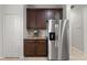 Modern kitchen features stainless steel refrigerator, granite countertops and dark wood cabinetry at 5047 Newport News Cir, Bradenton, FL 34211