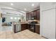 Modern kitchen with stainless steel appliances, granite counters, and an open view to the living area at 5047 Newport News Cir, Bradenton, FL 34211