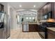 Open kitchen boasts stainless steel appliances, granite countertops, and dark wood cabinetry at 5047 Newport News Cir, Bradenton, FL 34211