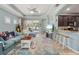 Spacious living room featuring modern decor, neutral tones, and an open layout to the kitchen at 5047 Newport News Cir, Bradenton, FL 34211