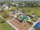A community playground with splash pad, swings, and covered seating areas, perfect for outdoor fun at 5047 Newport News Cir, Bradenton, FL 34211