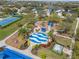 Aerial view of a community splash pad and playground with seating and covered play areas at 5047 Newport News Cir, Bradenton, FL 34211