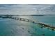 Scenic aerial view of a bridge over clear water with boats and a distant cityscape at 5074 Flagstone Dr, Sarasota, FL 34238