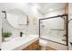 Modern bathroom featuring dual undermount sink, hardwood cabinets, and glass shower at 5074 Flagstone Dr, Sarasota, FL 34238