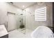 Elegant bathroom featuring glass shower, tub with jets and marble tile throughout at 5074 Flagstone Dr, Sarasota, FL 34238
