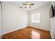Bedroom with hardwood floors, ceiling fan and flat screen TV mounted to the wall at 5074 Flagstone Dr, Sarasota, FL 34238