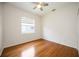 Bedroom featuring hardwood floors, a ceiling fan and a view of the outdoors at 5074 Flagstone Dr, Sarasota, FL 34238