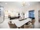 Open-concept dining area with large dining table, modern lighting, and seamless connection to the kitchen at 5074 Flagstone Dr, Sarasota, FL 34238