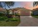 Beautiful single-story home featuring a well-manicured lawn, tile roof, and paved driveway leading to the two-car garage at 5074 Flagstone Dr, Sarasota, FL 34238