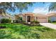 Charming single-story home with lush landscaping and a two-car garage at 5074 Flagstone Dr, Sarasota, FL 34238