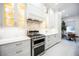Modern kitchen with sleek stainless steel appliances, white cabinets, granite countertops, and ample storage at 5074 Flagstone Dr, Sarasota, FL 34238